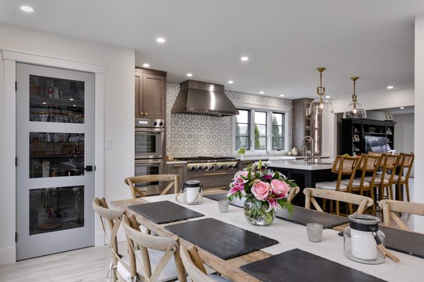 Open concept kitchen,dining with glass door pantry.