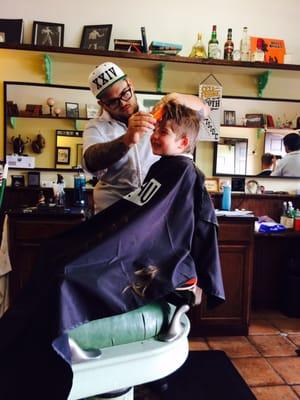 Getting his hipster cut with a smile!!!