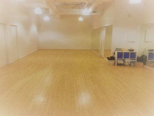 Large open yoga studio with bamboo floors hosts a variety of yoga and Pilates classes 6 days per week.