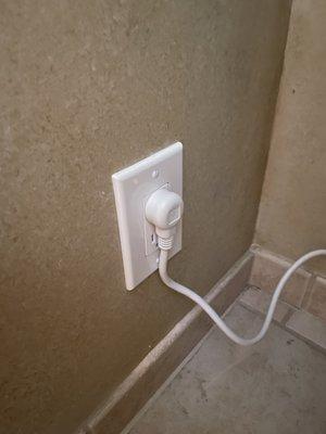 New electrical plug installed in bathroom.