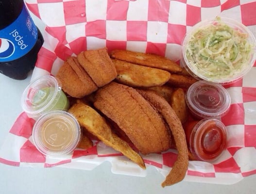 Flounder and seasoned potato wedges with homemade coleslaw with homemade organic sauces