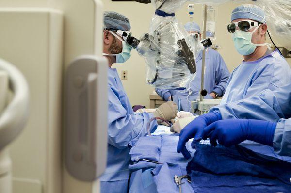 Spine Hospital of Louisiana surgeons, physician assistants, and scrub techs working as one to relieve this patient's back pain