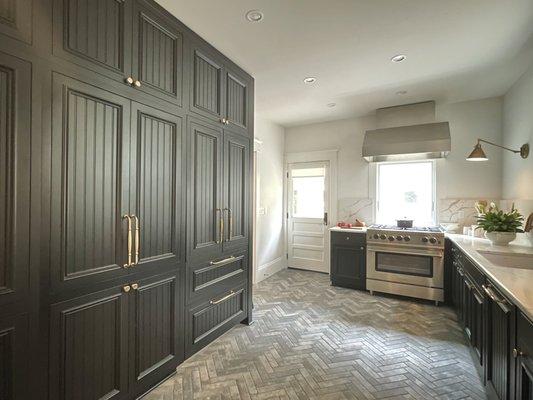 This Kitchen is striking as a black and white design, no uppers on the right, with the pantry and refrgerator on the left.