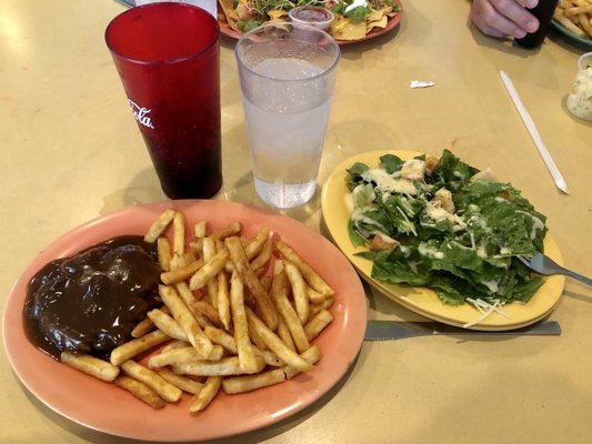 Hamburger Steak (hold the mushroom and onions) with sides of fries and Caesar salad.