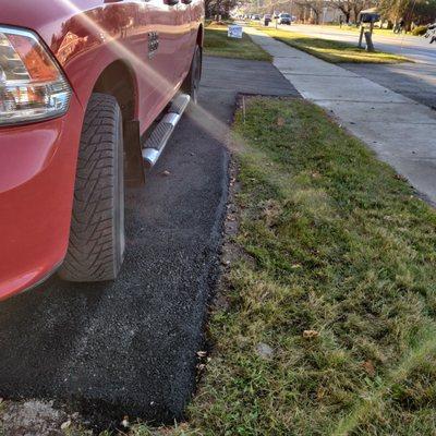 Raised pavement as contractor did not dig out old drive.