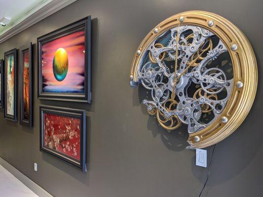 Clock "Quarter Till" by Dale Mathis on display next to original paintings by Patrick Guyton