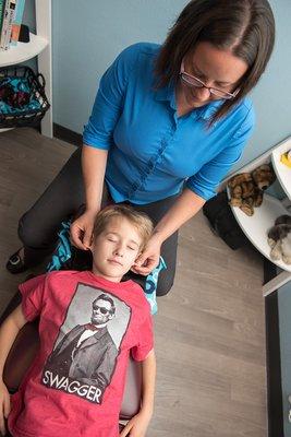 Dr. Beth performing Cranial Sacral Therapy on an 8 year old