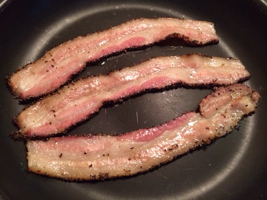 Marc & Alison's Hickory Smoked Peppered Bacon frying up this morning.