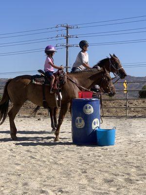 Miss Stephanie and a student in the arena working on their patterns and communication with your horse.