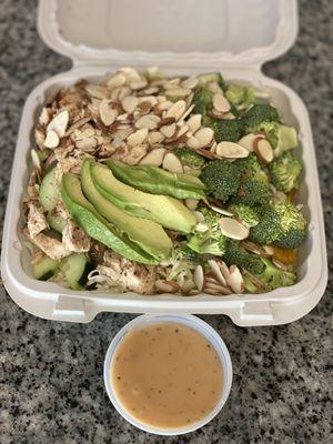 Sesame chicken salad with a most delicious sesame dressing!! I had them add broccoli, avocado and cucumbers :)