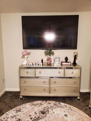 70 inch Sharp Aquos TV centered over dresser with flush wall mount.