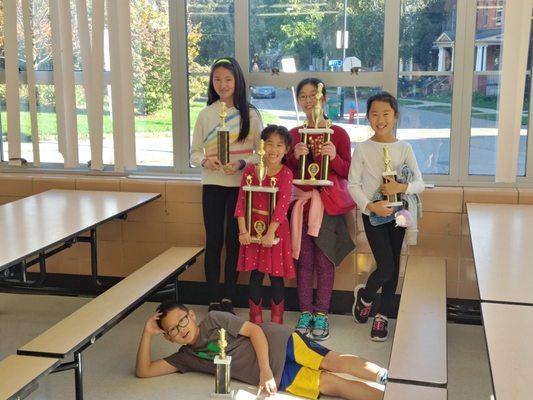 BCA students showing off their trophies from a 2019 tournament hosted by Black Knights Chess.