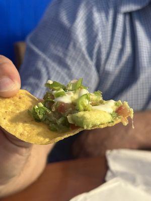 Guacamole Mexican with jalapeños and a drizzle of queso