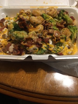 Baked potato w steak shrimp bacon broccoli sauce sour cream