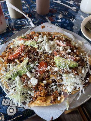 Tostada Mixta has pork, steak and chorizo. This tostada is the size of medium pizza. It is so delicious!