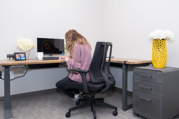 One of our private offices. All private offices can seat 2 people, include a sit/stand desk, and storage pod.