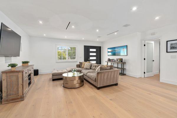 Flooring, recessed lights and main entry door by ADU Builder and Construction, Inc.