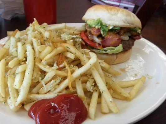 Bacon cheeseburger with avocado and garlic fries.