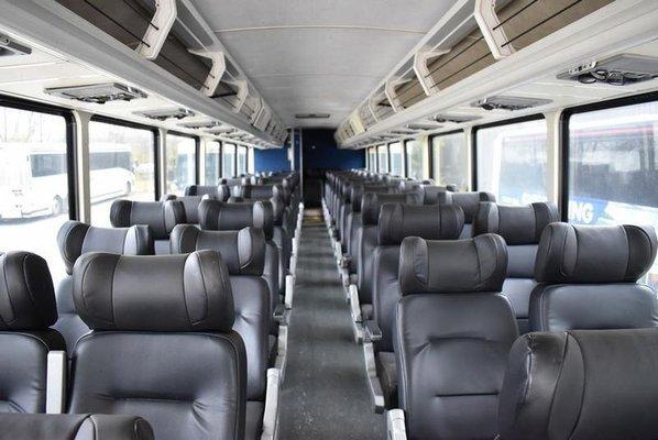 Interior of a Newer Greyhound Bus. It has improved Luggage Racks, Temperature Controls, Headrests, & Reading Lights.