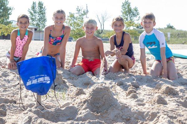 Building sand castles at kids' beach camp