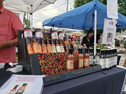 Bottles of Amazing Hazel's hot sauces and glazes on a table.