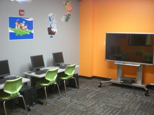 Children's College - technology room with computers, iPads and a smartboard.