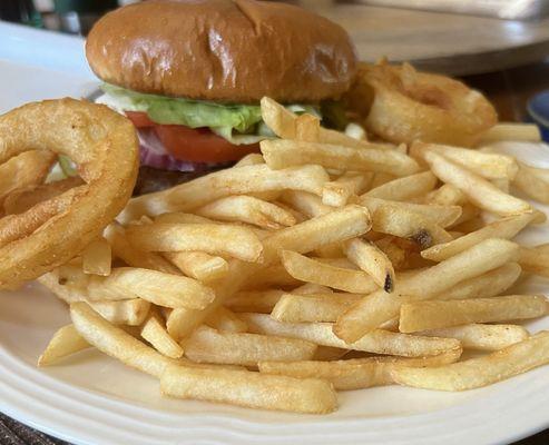 Hamburger with fries and some onion rings.