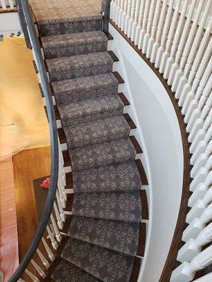 beautiful pattern carpet on a curved staircase