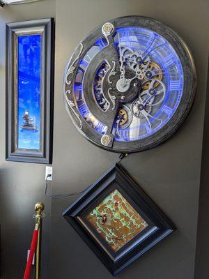 Another Mechanical Clock by Dale Mathis alongside Patrick Guyton original paintings on precious metal leaf