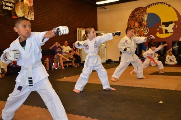 Beginner white belts learning basic technique.