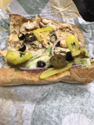 Roasted chicken, onions, peppers, olives, banana peppers, and lettuce with sweet onion and chipotle sauce. Thank me later :)