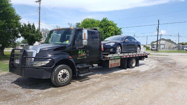 Our guys moving a Tesla Model S. We are a preferred provider for luxury tows with multiple roadside companies!