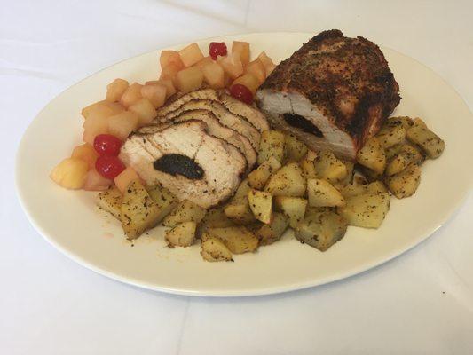 Pineapple-cherry-glazed Pork with potatoes in a chimichurri sauce