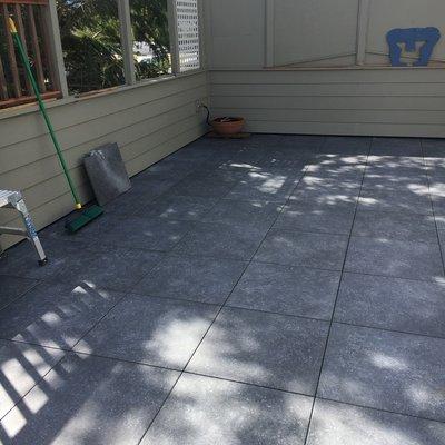 2x2 Porcelain Pavers Installed On Top Of Adjustable Pedestals. Pedestals Sit Atop Old Patio (Poured Concrete)