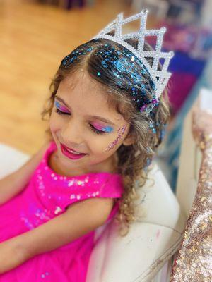 6 year old girl with a tiara wearing makeup and glitter