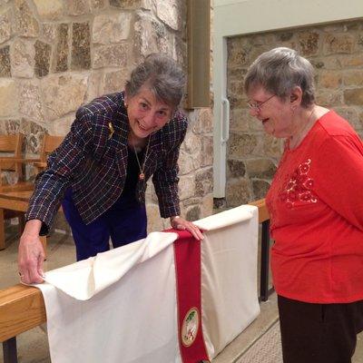 Volunteers prepare the altar for every service.