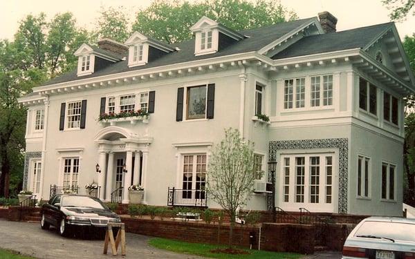 Exterior upgrade removed old iron covering lower windows and door repair to stucco and painting