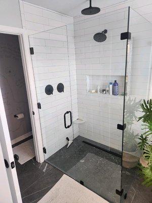 Tiled bathroom with a glass enclosure