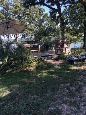 Community hot tub. Overgrown and in disrepair with junk all over the place