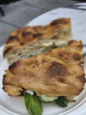 Beet and feta sandwich on focaccia. Also has cucumber,  mint and cilantro.   Yum