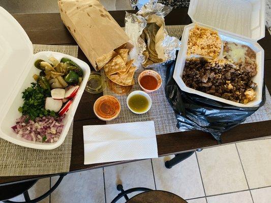 Asada plate with jalapeño and onion and chips and extra tortillas and what else!? Yum