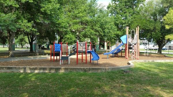 Children's play area is fenced from the sidewalk.