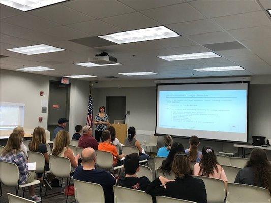 Beth Barteletti of International College Counselors gives a free presentation to parents and students at the library.