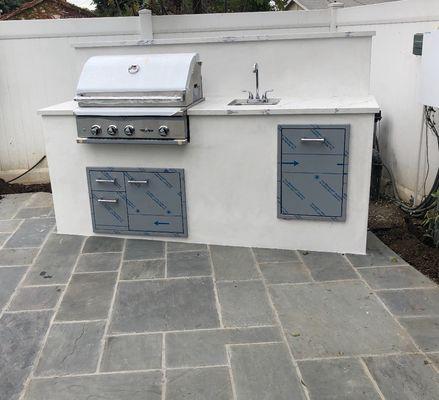 BBQ setup hooked up with gas and water. Includes a drain too!