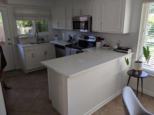 Cam replaced our countertops, added an under-mount sink, created the new peninsula, and installed the subway tile backsplash.