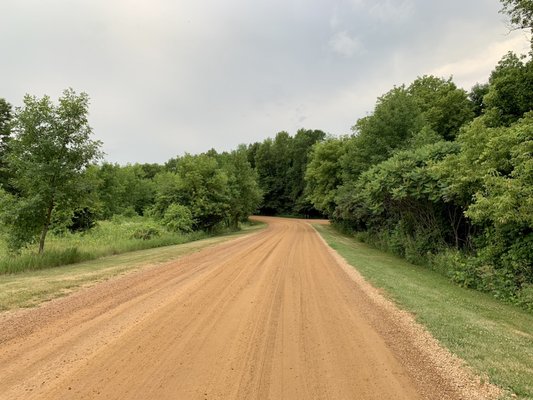 The entrance road extends all the way into the woods.