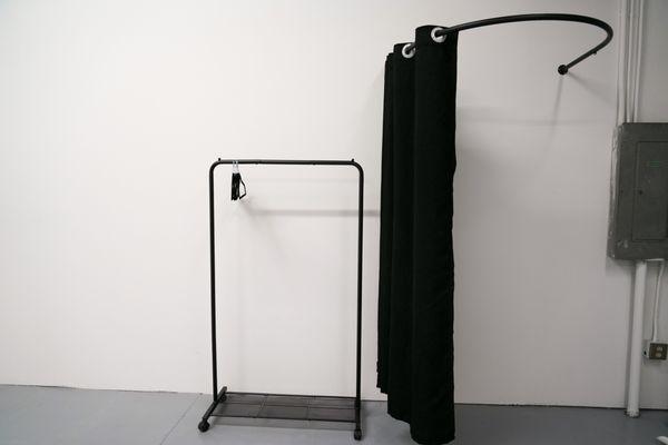 Warehouse space. Built in changing room and three clothing racks for your convenience!