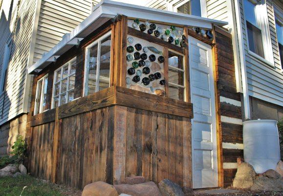 This semi-permeable greenhouse uses a solar shade to water the plants within, and is built with mostly free and recycled materials