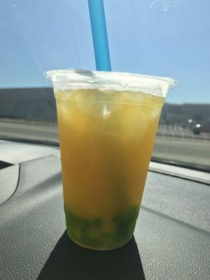 Passion fruit and peach green tea with popping peach boba and green tea jellies. (Size small)