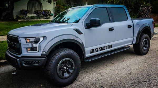 Ford Raptor wrapped in Matte light grey and custom graphics on the side